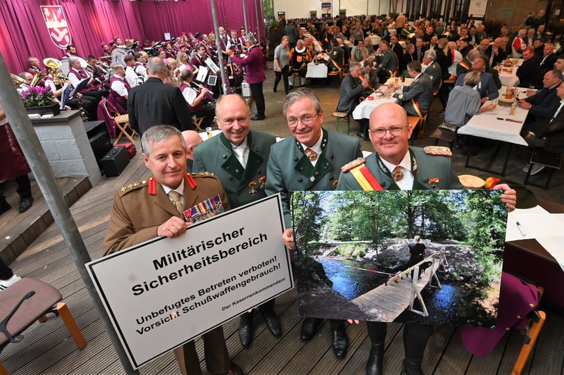 Den Streit um die Thune-Wiesen in Mastbruch und den illegalen Bau einer Brücke im militärischen Bereich thematisierte Oberst Thomas Spieker (rechts). Er überreichte dem britischen Kommandeur Tim Hill (links) ein neues Warnschild. Mit im Bild: Landrat Christoph Rüther und Bürgermeister Michael Dreier.