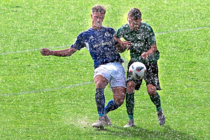 Feuchte Angelegenheit: Münsters Thorben Deters und Schalkes Julius Schell duellieren sich im Regen.