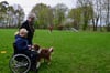 In der Ausbildung lernen viele Hunde zum ersten Mal einen Rollstuhl näher kennen. Für den Hund von Leiterin Anne Lütke Föller (h.) ist er nichts Neues. Trainerin Ann-Christin Thiel hat sich fürs Training in den Rollstuhl gesetzt.