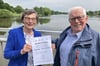 Ursula Warnke, die Vorsitzende des Stadtheimatbundes, und Karlheinz Pötter laden zur Geburtstagsfeier für den Paula-und-Otto-Modersohnweg am Aasee ein.