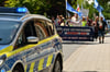 Der Protestzug ist auf der Johanniterstraße in Bad Oeynhausen unterwegs. Zwei Polizeifahrzeuge fahren voraus, eines bildet den Abschluss.